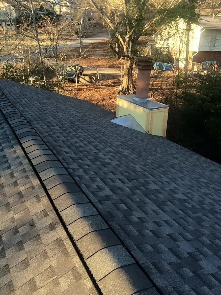 Close-up view of asphalt shingle roofing surface showing granule texture and condition